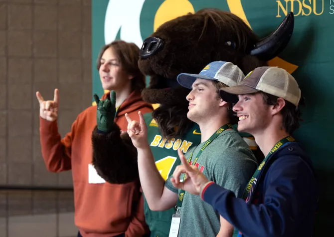 students posing for photo with Thundar during Discover NDSU