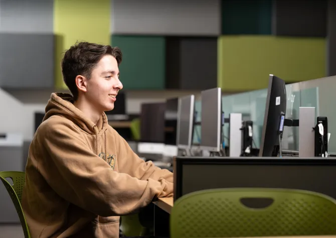 data science student works at computer in computer lab