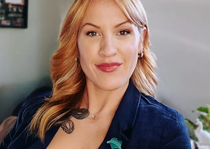 Picture of Jani Western in a blue blazer smiling at the camera