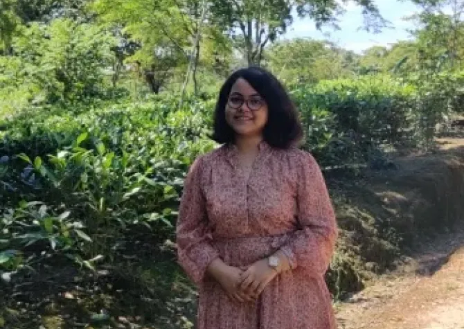 Sukanya smiling confidently at camera.