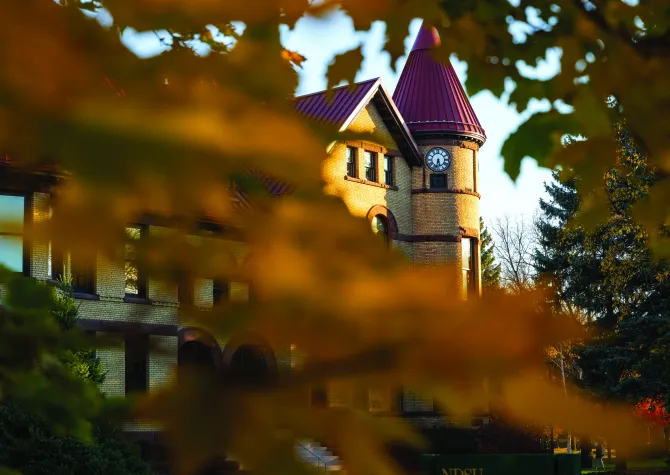 Old Main behind fall trees