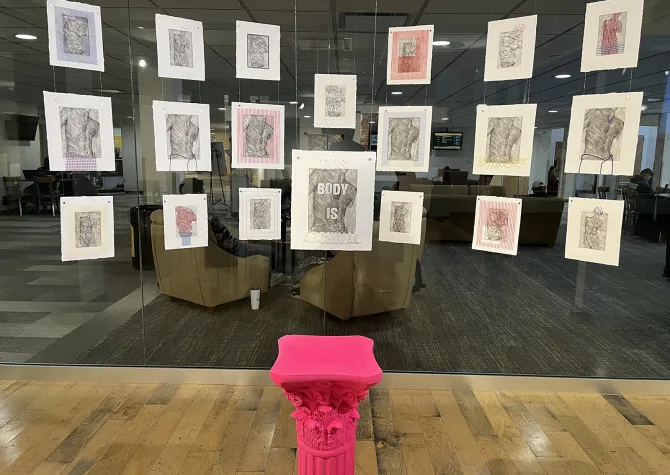 Image of installation featuring prints and sewing