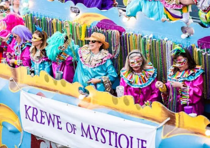 people in colorful jester costumes cheering