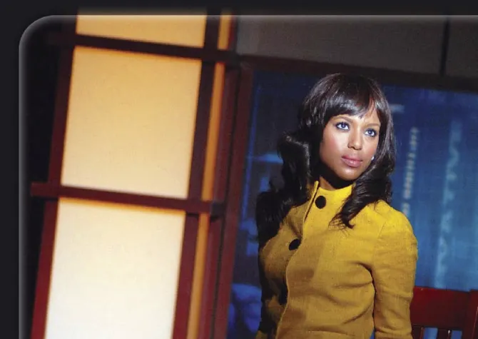 Kerry Washington staring off camera, sitting on a chair