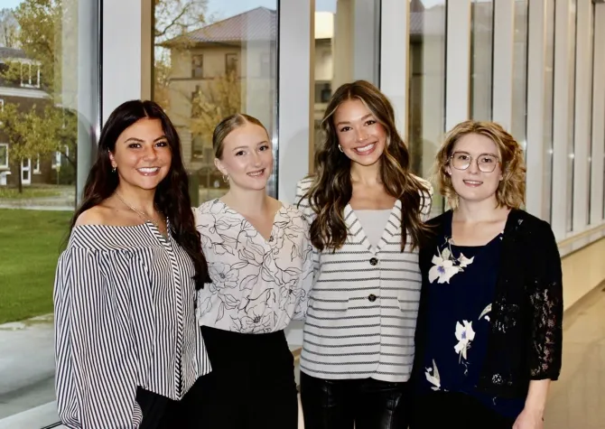 Four Women smiling confidently at camera.