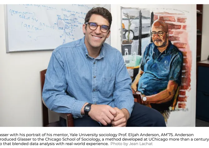 man with glasses smiling at camera with painting of man in background