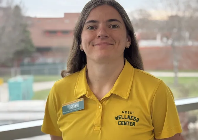 Robyn M in yellow wellness center shirt