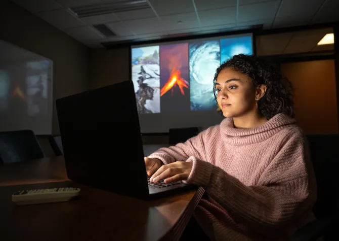 student in Emergency Management working on a computer