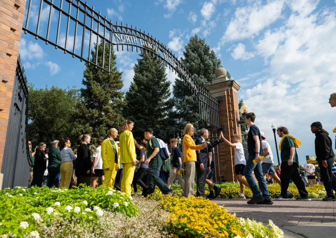 president stewart and first lady greet new students as they walk through the NDSU gates