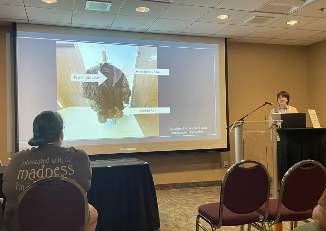 Student presenting at podium.