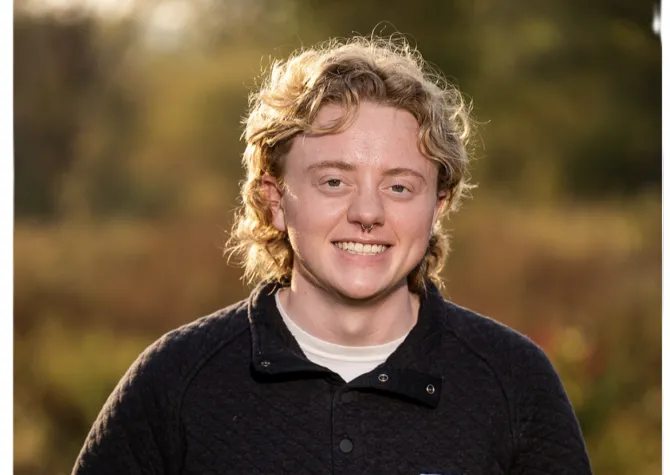 Aaron smiling confidently at camera.