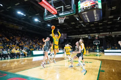 Bison women's basketball player shooting a layup at the net