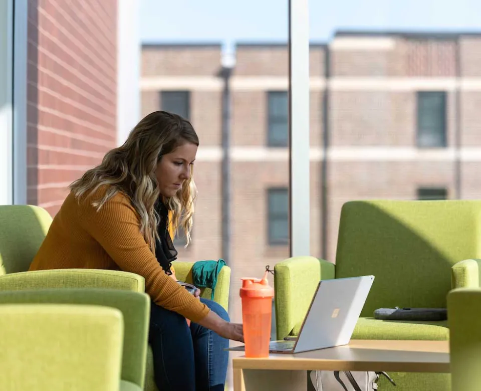 Student working on laptop in A.G. Hill study space.