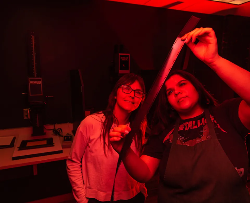 Students working in the photography studio darkroom