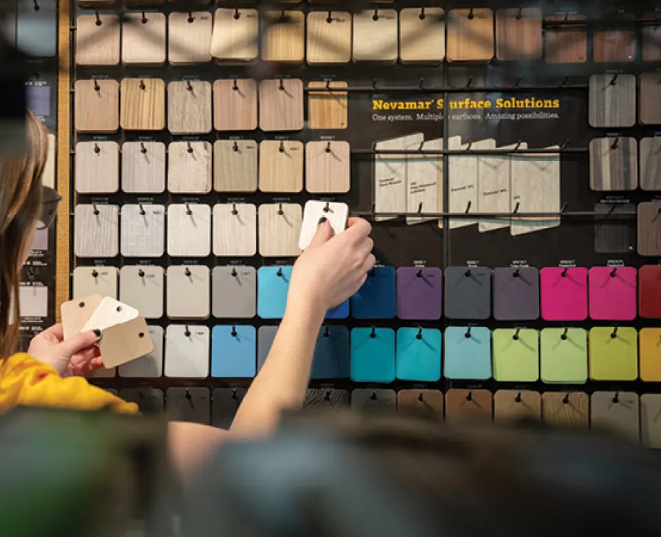 Student working with color samples in design studio.