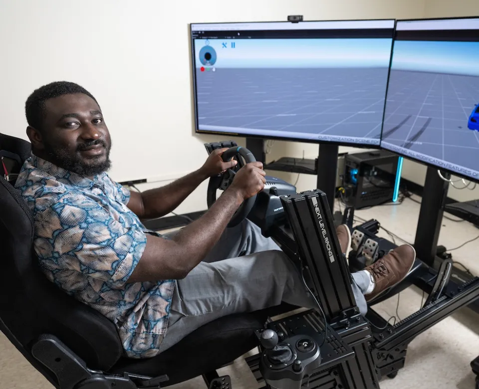 A photo of NDSU professor Armstrong Aboad at a VR research station