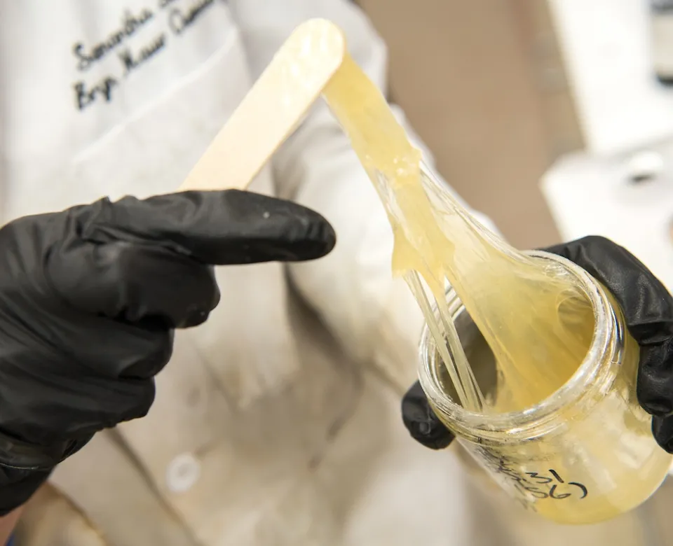 Scientist working with coating substance in lab.
