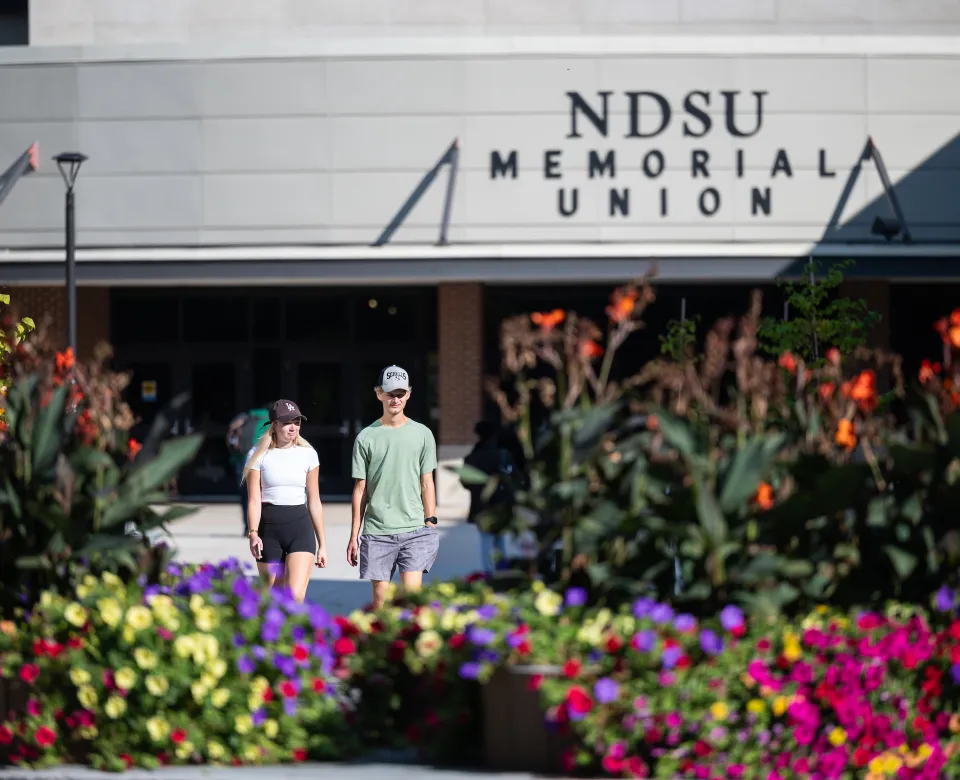 Students walking in front of the NDSU Memorial Union during the spring. 