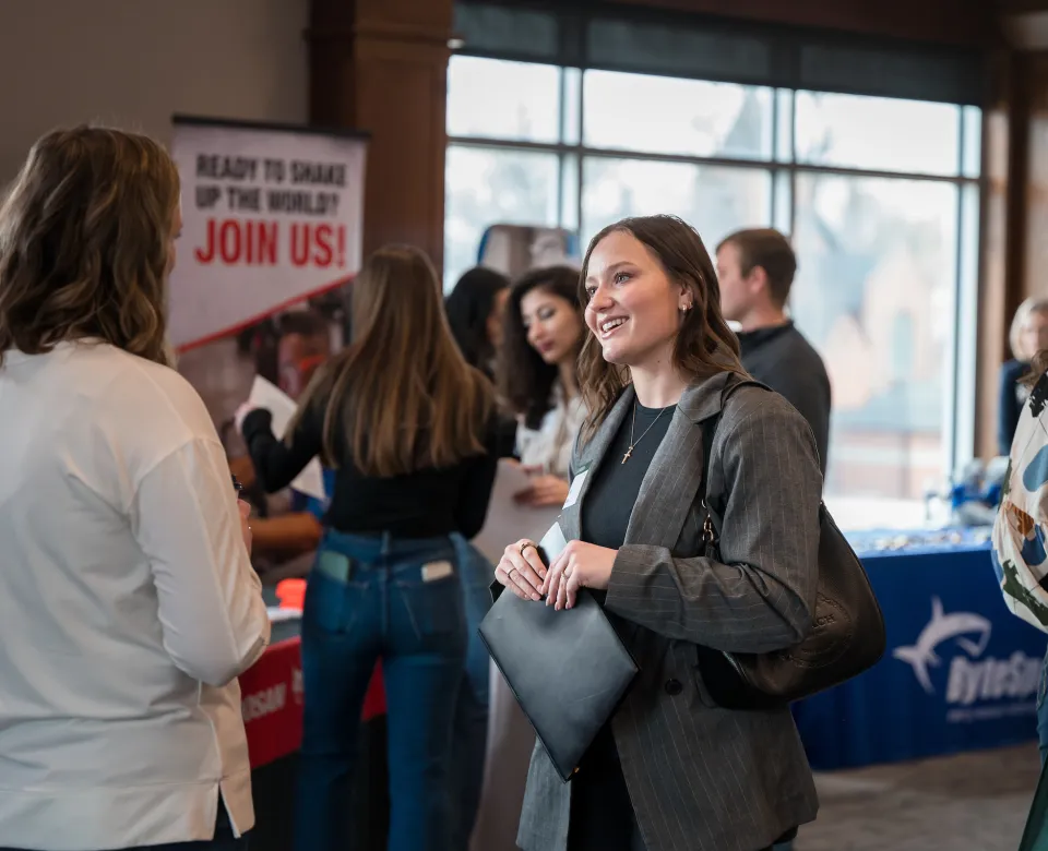 women talking at an expo