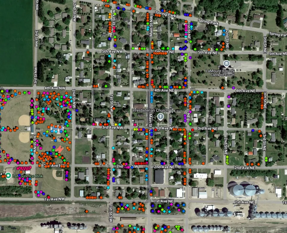 A map of a town with color coded dots to represent different species of trees