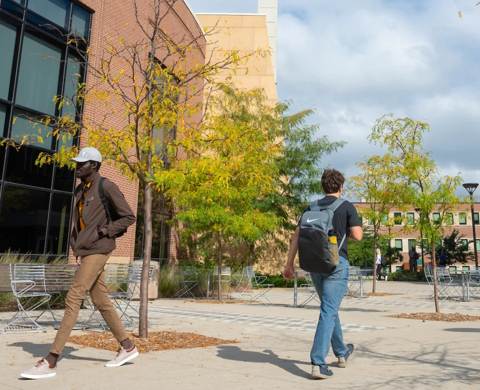 students walking between Memorial Union and A. Glenn Hill buildings