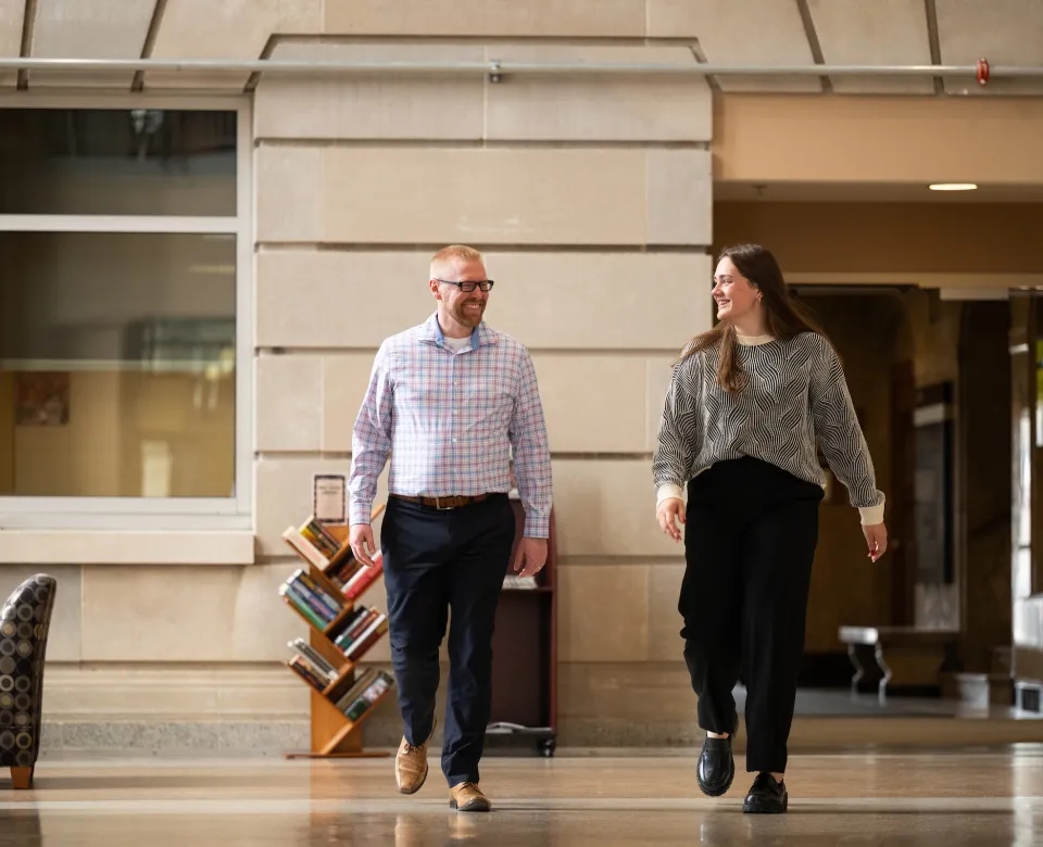 Advisor and student walking in Barry Hall
