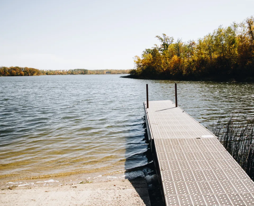 A dock extends out into a lake