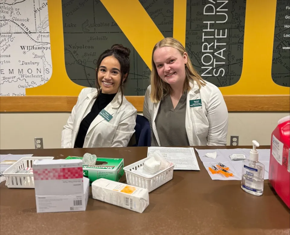 Two NDSU students helping out at the campus flu vaccine clinic