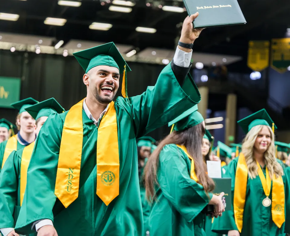 students earning their diplomas at commencement