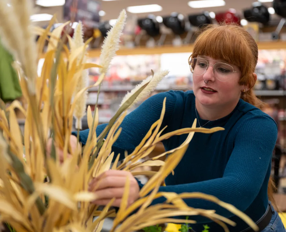Interior design student working on a flower arrangement.
