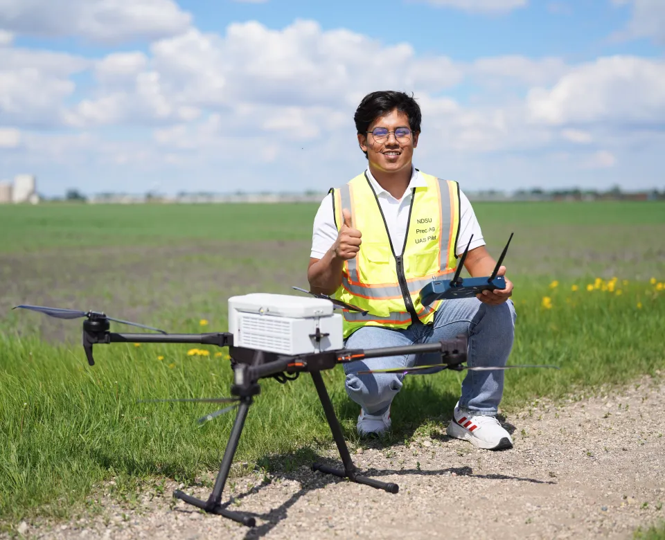 College of Ag Student with Drone in Field