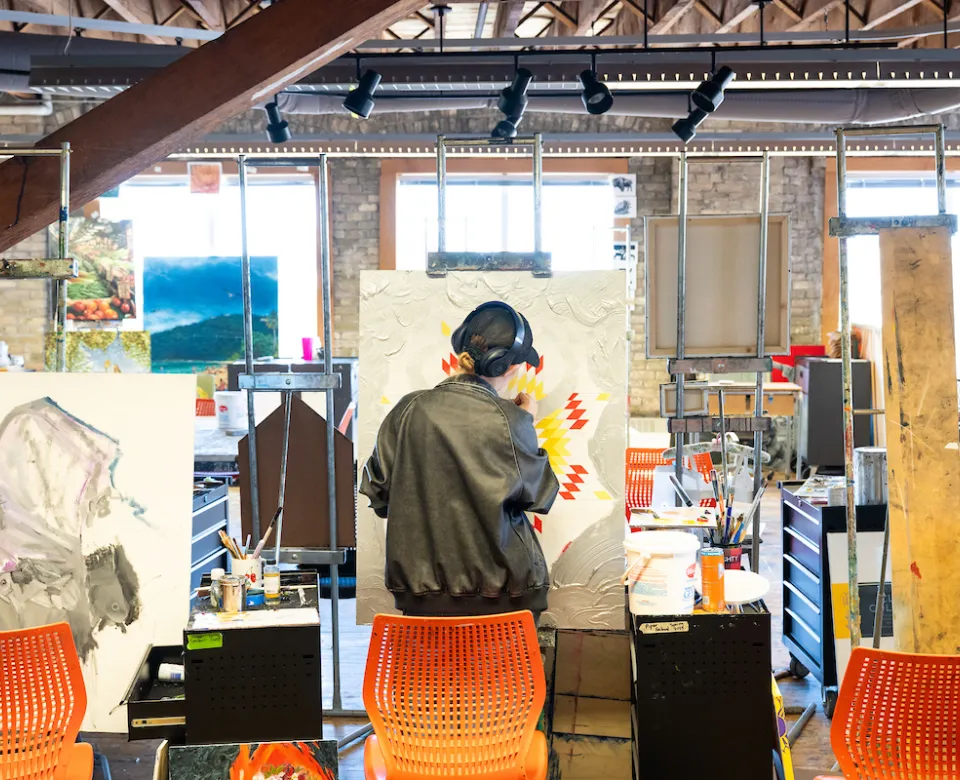 Art student working on project in art studio.