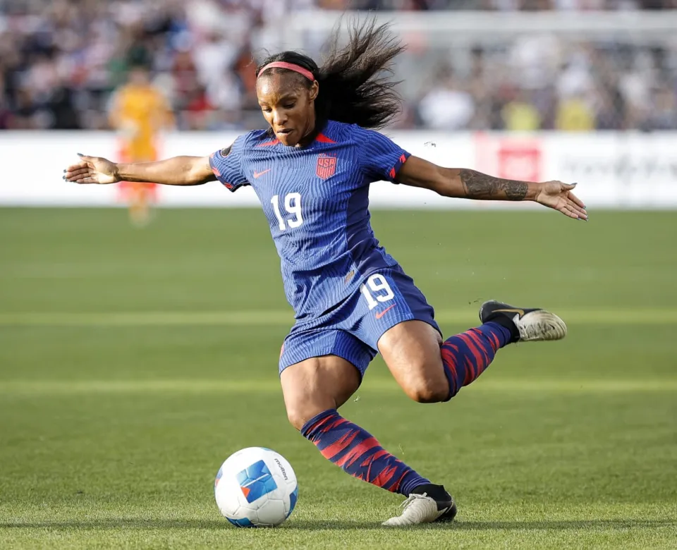 woman about to kick a soccer ball