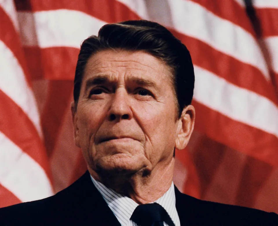Ronald Reagan in front of American flags