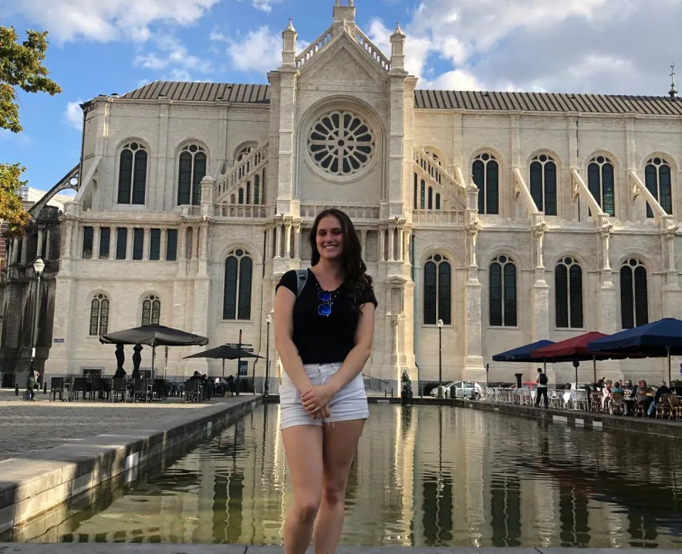 Student in front of Church of St. Catherine in Brussels.