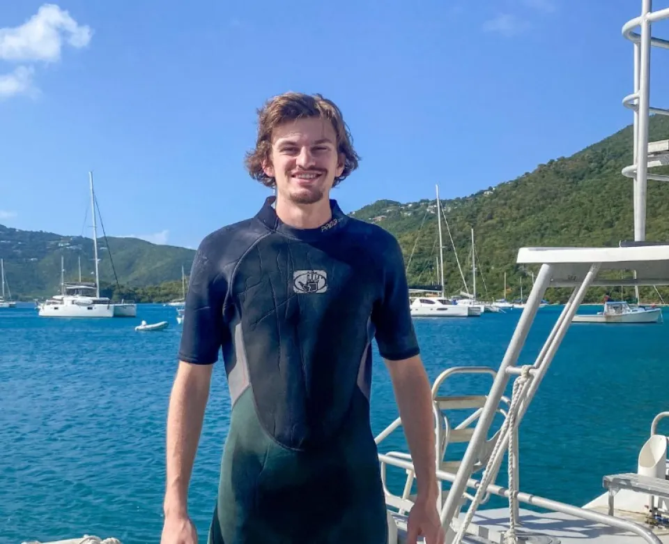 A student on a boat in snorkeling gear