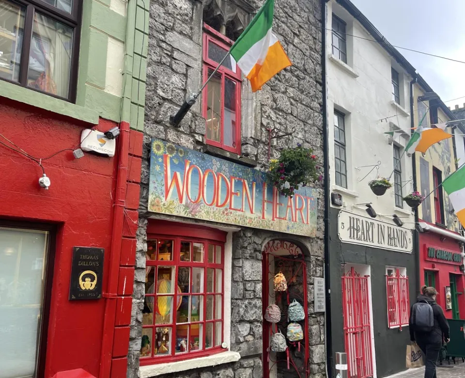 Street of shop called "Wooden Heart" with the Irish flag above it