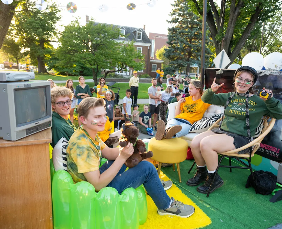 students participate in the Homecoming parade with their float