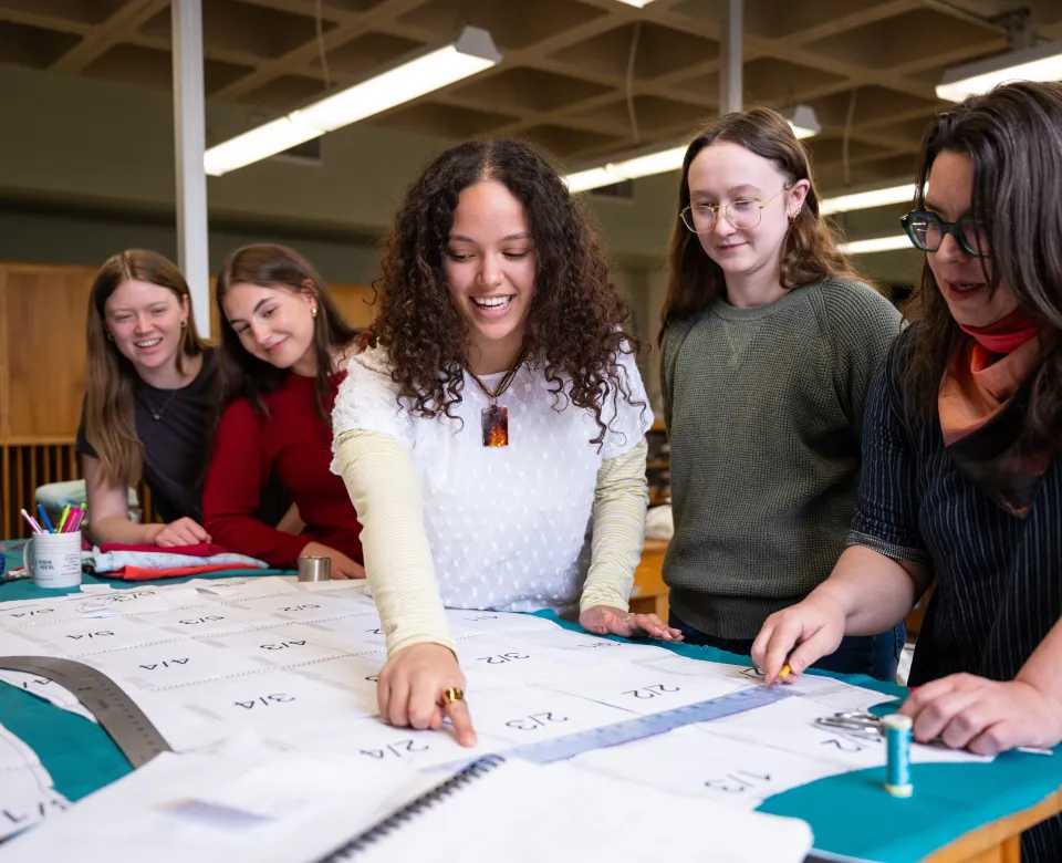 A group of NDSU students look at fabric choices