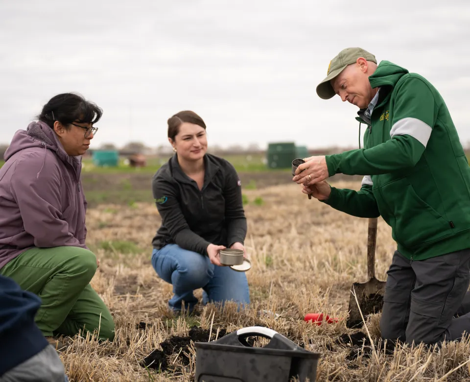 Tom DeSutter, professor of Soil Science, interacts with students in the field