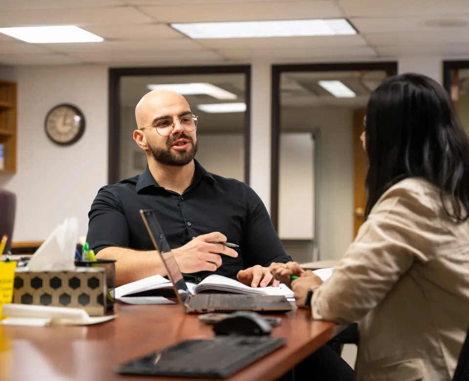 graduate students discuss coursework