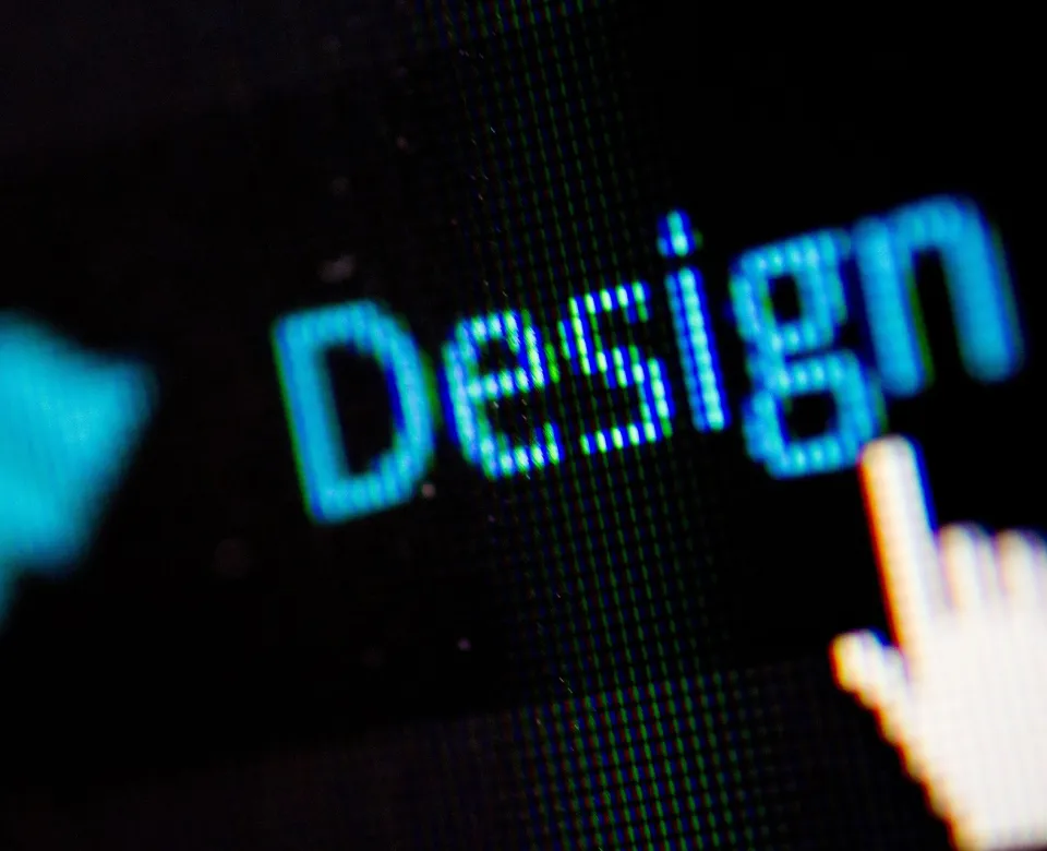 A hand pointing to the word design