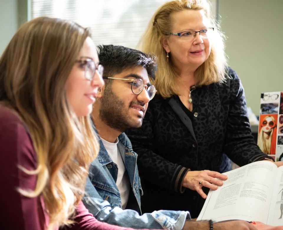 Students and teaching looking at something intently.
