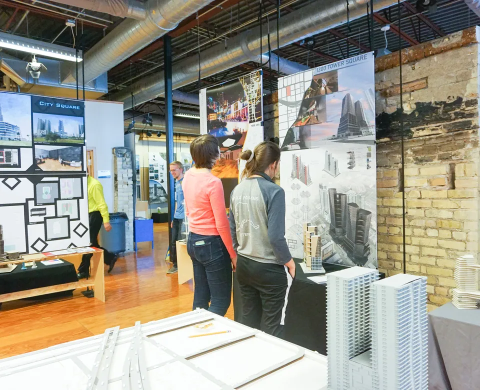 Two students viewing artwork in the 5th Floor Gallery.