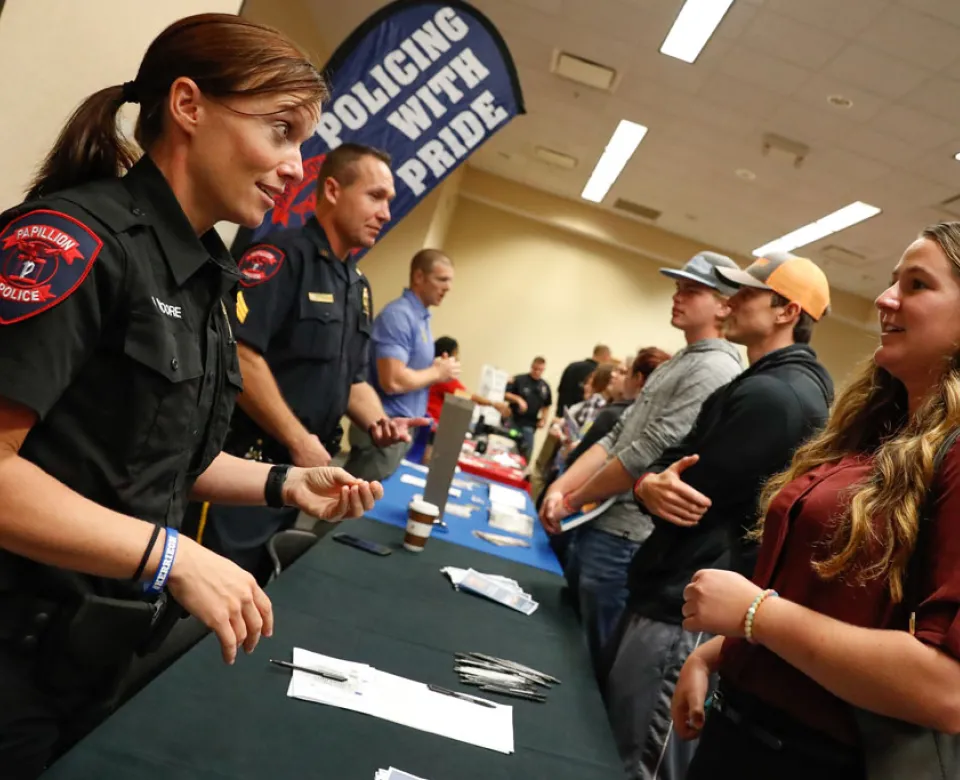 Students visiting at event table. 