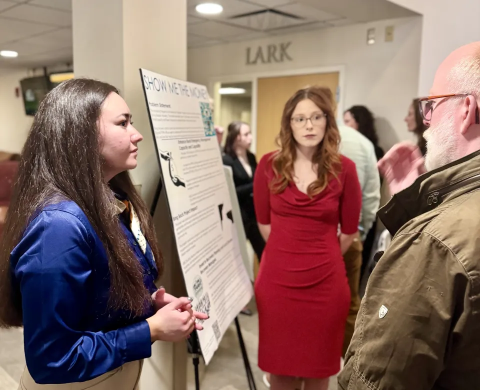 Students present poster research. 