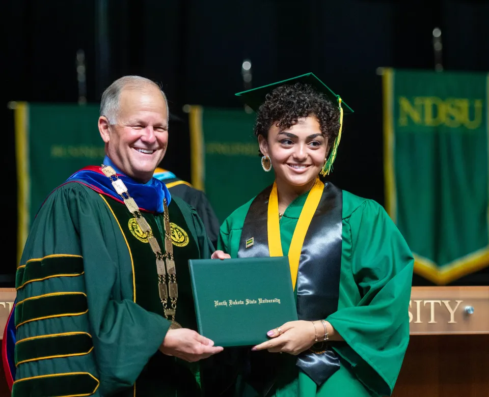 NDSU student getting diploma at commencement