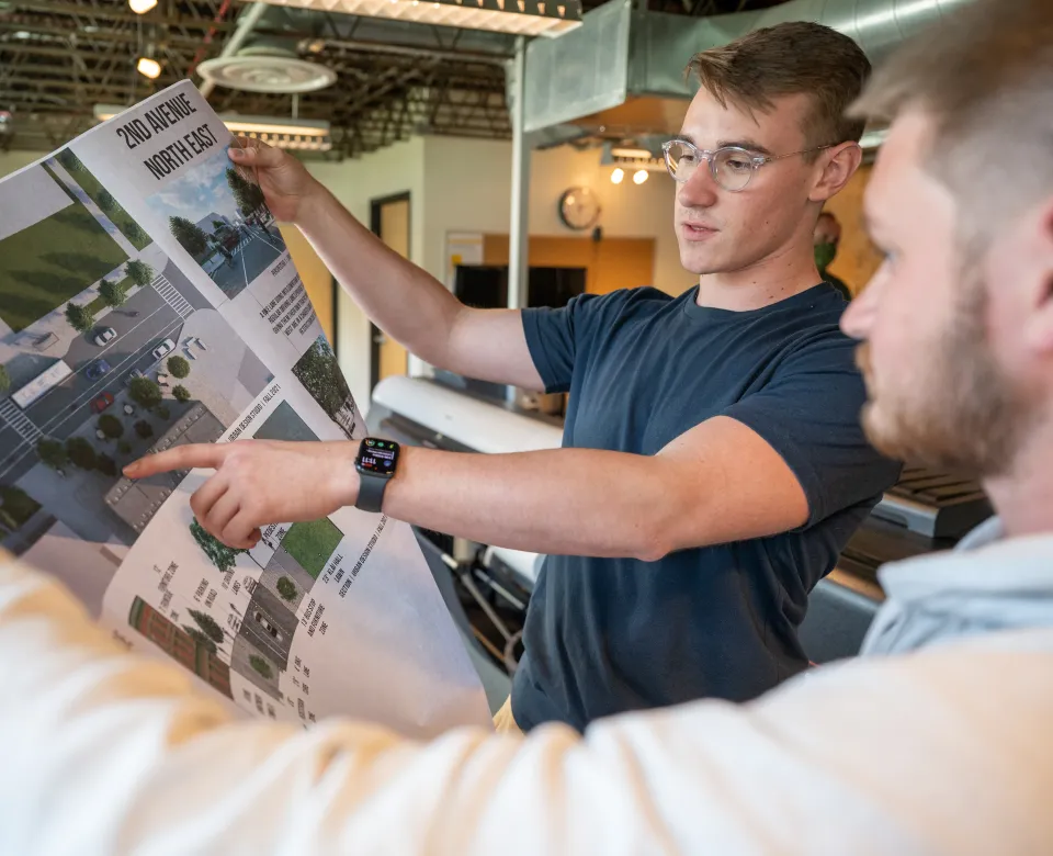 Students looking at a design rendering.