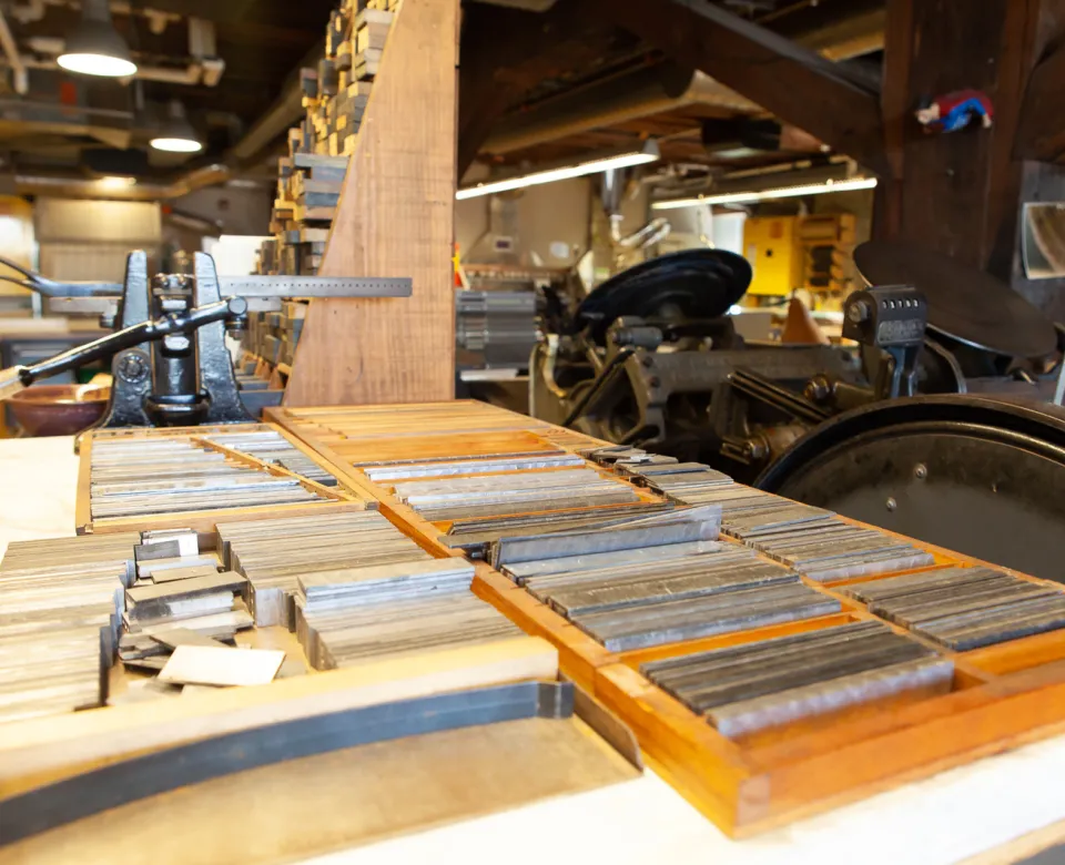 Printmaking supplies and equipment on tables in printmaking studio.