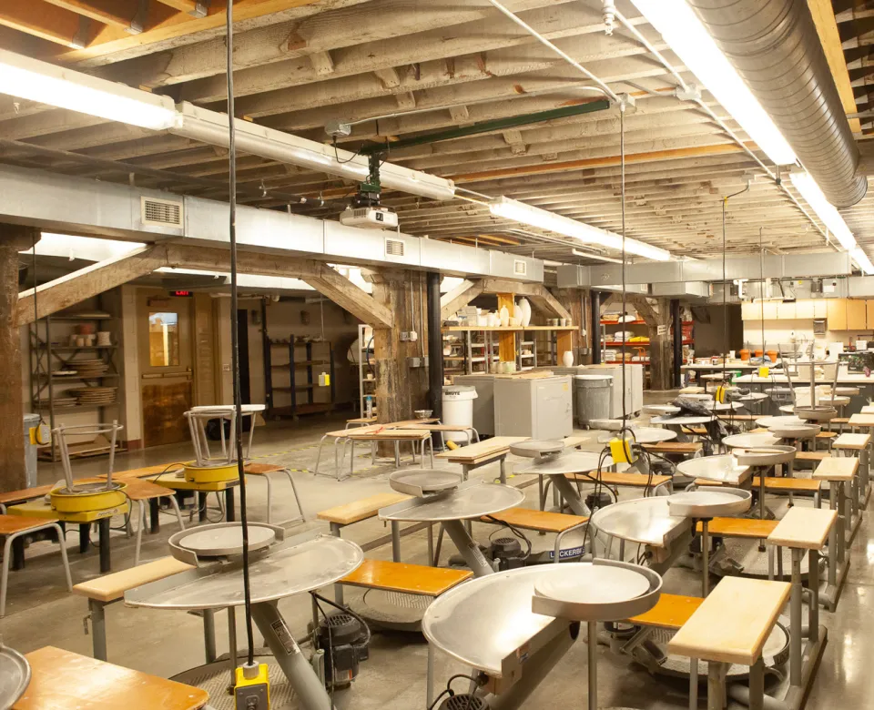 Ceramics Studio with throwing stations and chairs.